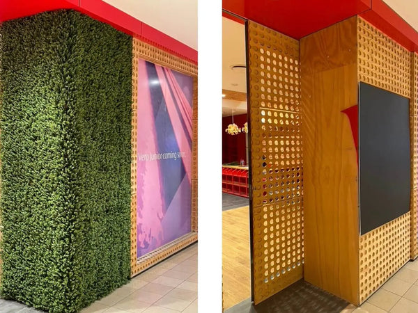 Faux boxwood hedge panels on a retail display column beside timber screens