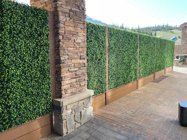 Green screening panels between wooden posts on a ski resort terrace in Colorado