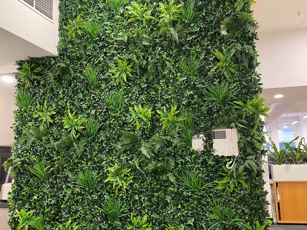 Tall artificial green wall in a bright interior