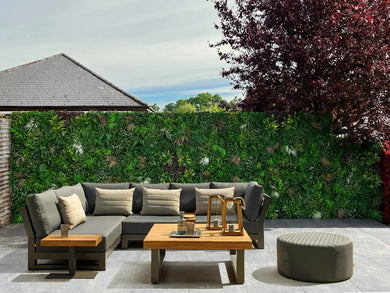 Backyard renovation with plastic plant wall panels and extra foliage added into the panels