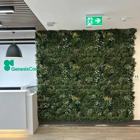 Artificial green wall panel on a lobby wall beside a corridor.